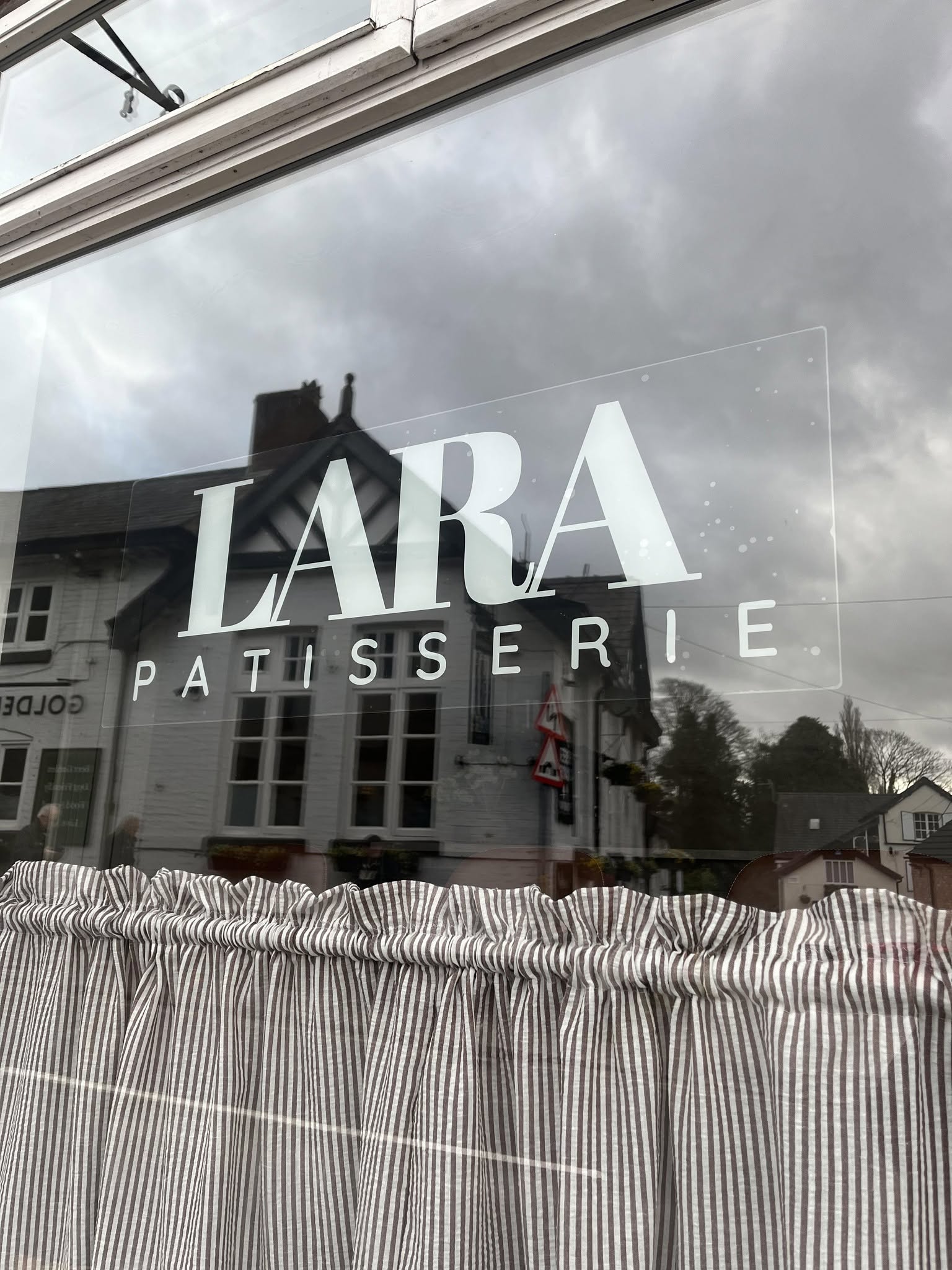 The Lara Patisserie shopfront window on The Cross in Lymm